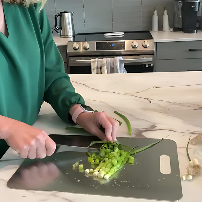Customer chopping vegetables on a titanium cutting board